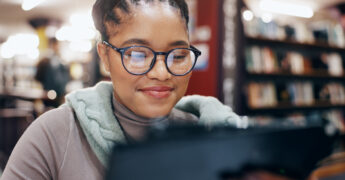 African, woman and smile with tablet in library for research information, university news and study schedule. Student, digital and reading online with education ebook, exam results and project report.